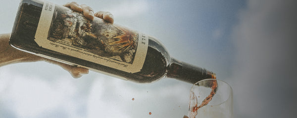 Pouring wine against a blue sky background