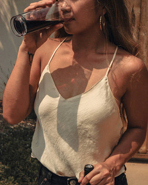 A woman drinking a glass of Rabble Wines' Cabernet