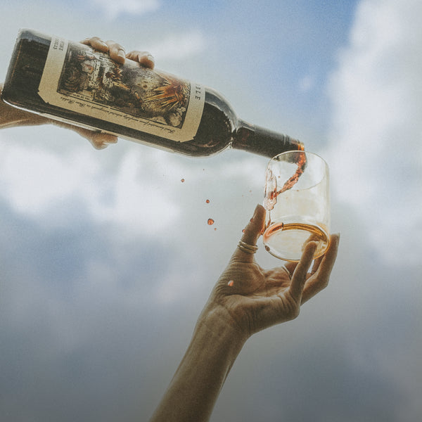 Pouring wine against a blue sky background