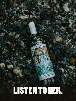 Sauvignon Blanc bottle in a lake with the caption "Listen to Her"