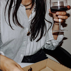 A woman holding a glass of Rabble Wines' Zinfandel